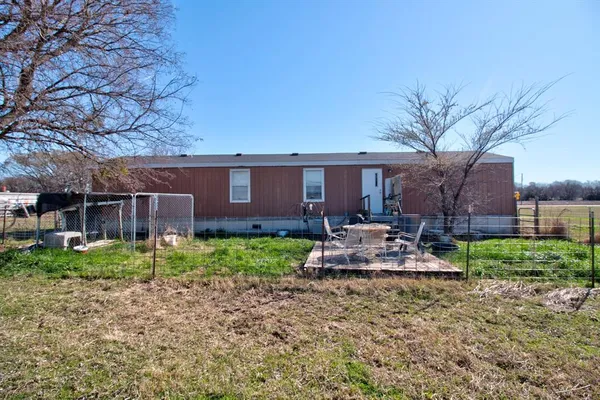 a view of a house with a yard and hanging chair