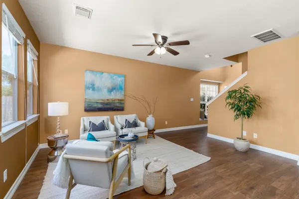 a living room with furniture and a potted plant