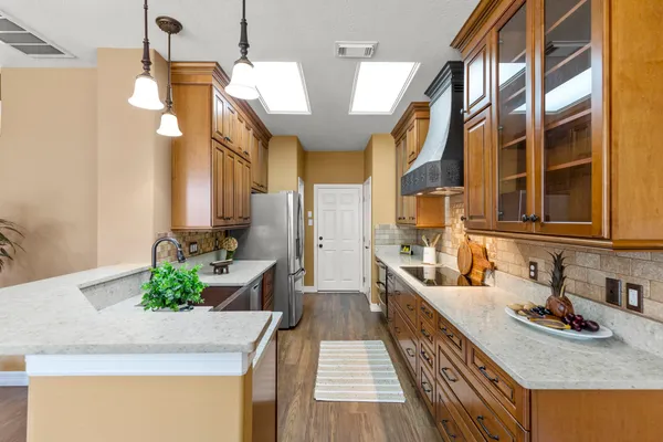 a kitchen with stainless steel appliances granite countertop a sink stove and cabinets