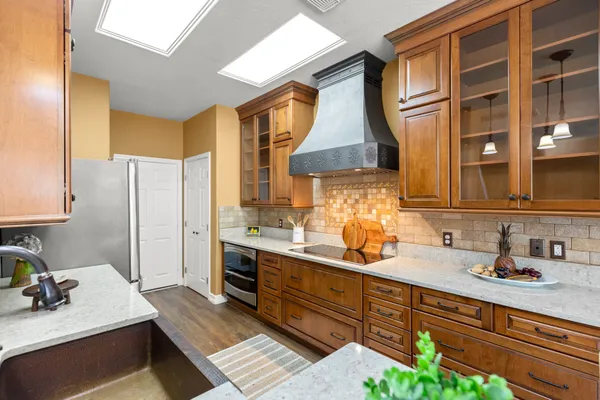 a kitchen with a sink stove and refrigerator