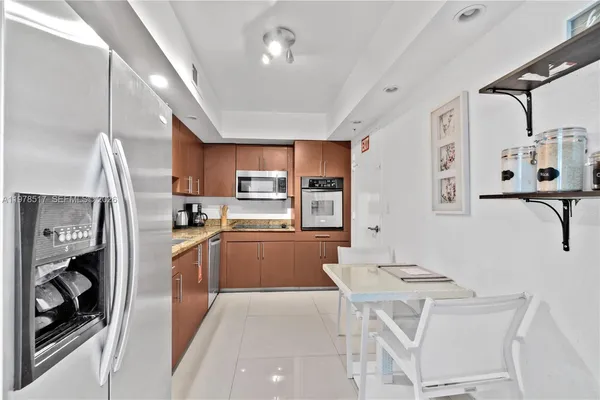 a kitchen with stainless steel appliances kitchen island granite countertop a sink and cabinets