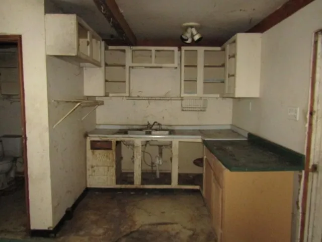 a kitchen with a sink and cabinets