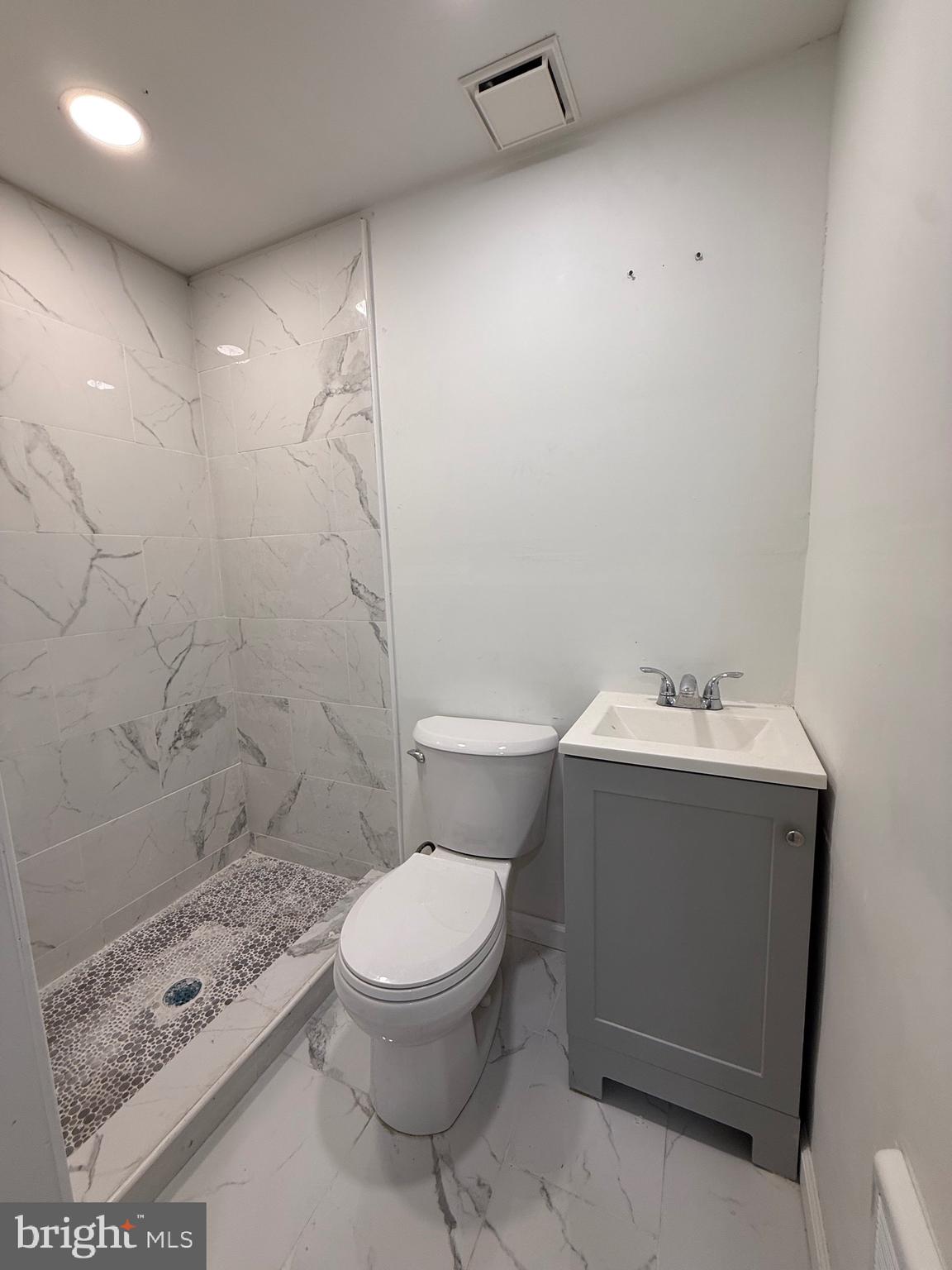 1153 Atwood Road, Unit 2 Philadelphia, PA 19151 - Photo 13 of 29 a white toilet sitting next to a bathroom sink