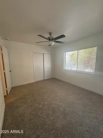 a view of empty room with a ceiling fan