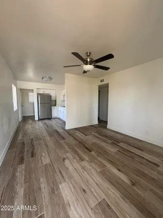 a view of a kitchen with a sink and a ceiling fan