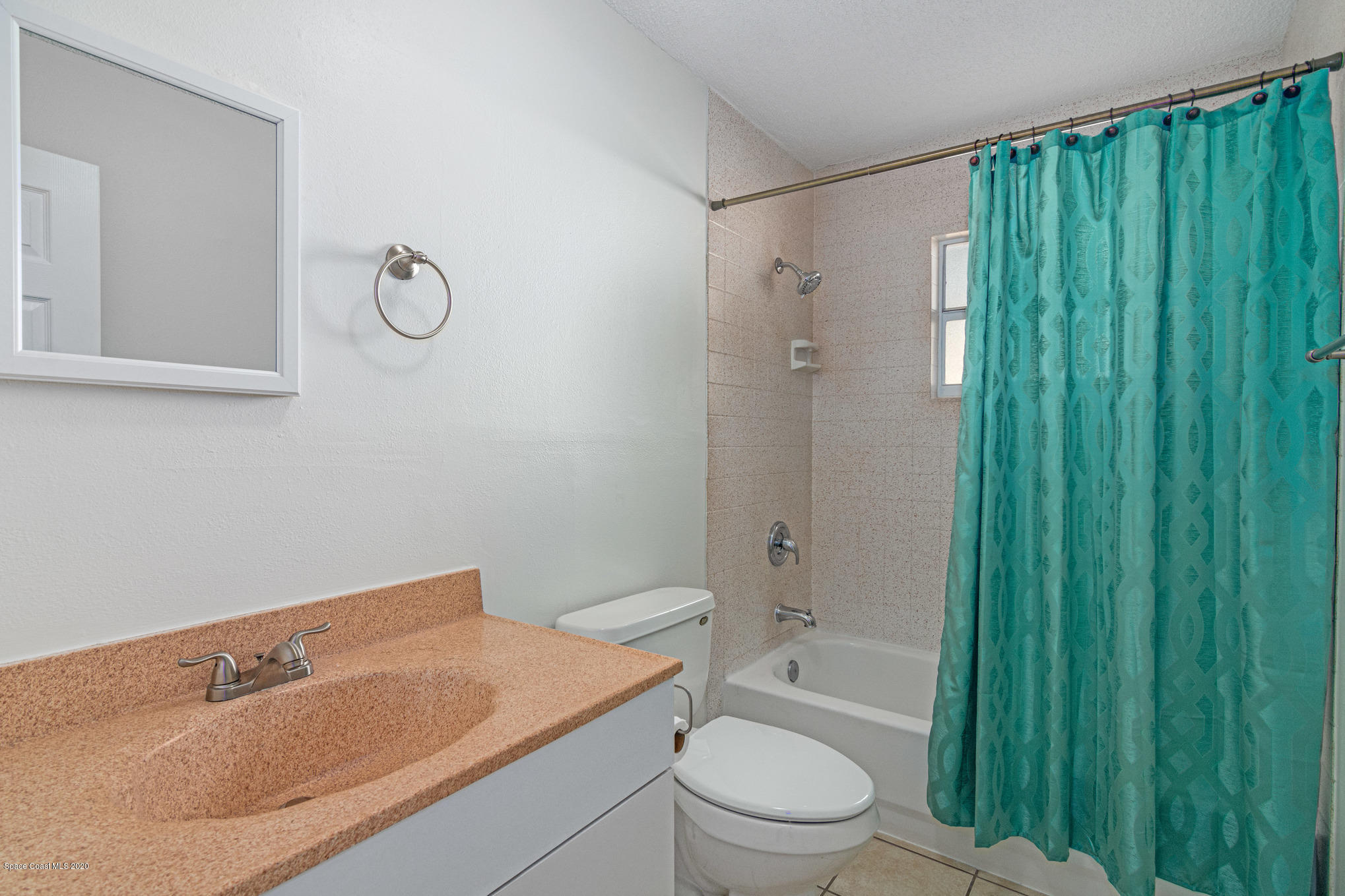 434 Count Street Melbourne, FL 32901 - Photo 20 of 26 a bathroom with a granite countertop sink a toilet and shower