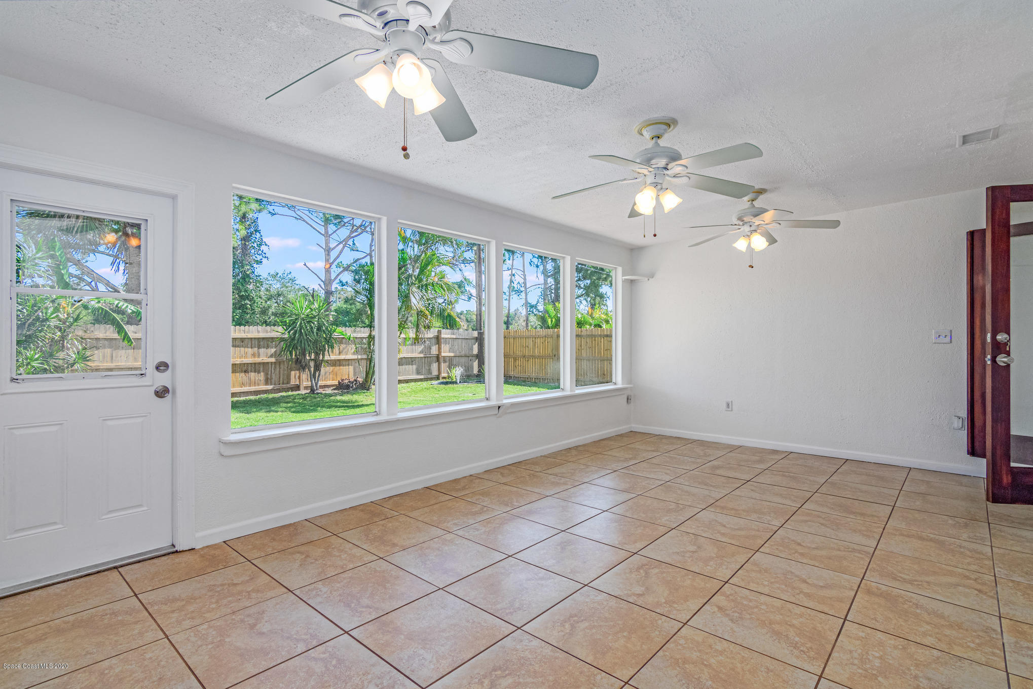 434 Count Street Melbourne, FL 32901 - Photo 23 of 26 a view of an empty room with a window and a fan