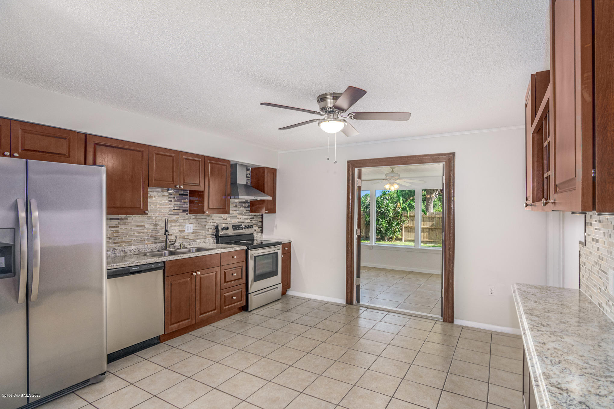 434 Count Street Melbourne, FL 32901 - Photo 6 of 26 a kitchen with stainless steel appliances granite countertop a refrigerator and a sink
