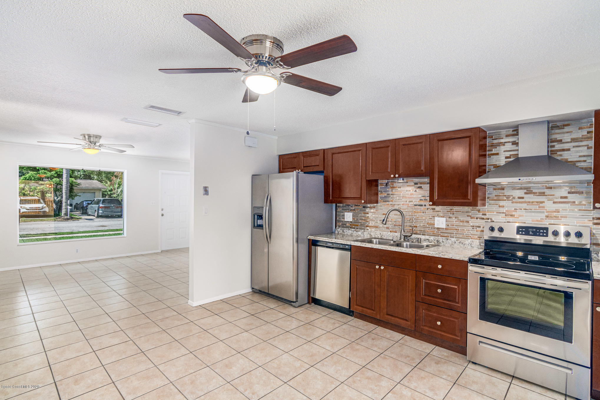 434 Count Street Melbourne, FL 32901 - Photo 7 of 26 a kitchen with stainless steel appliances granite countertop a stove sink and cabinets