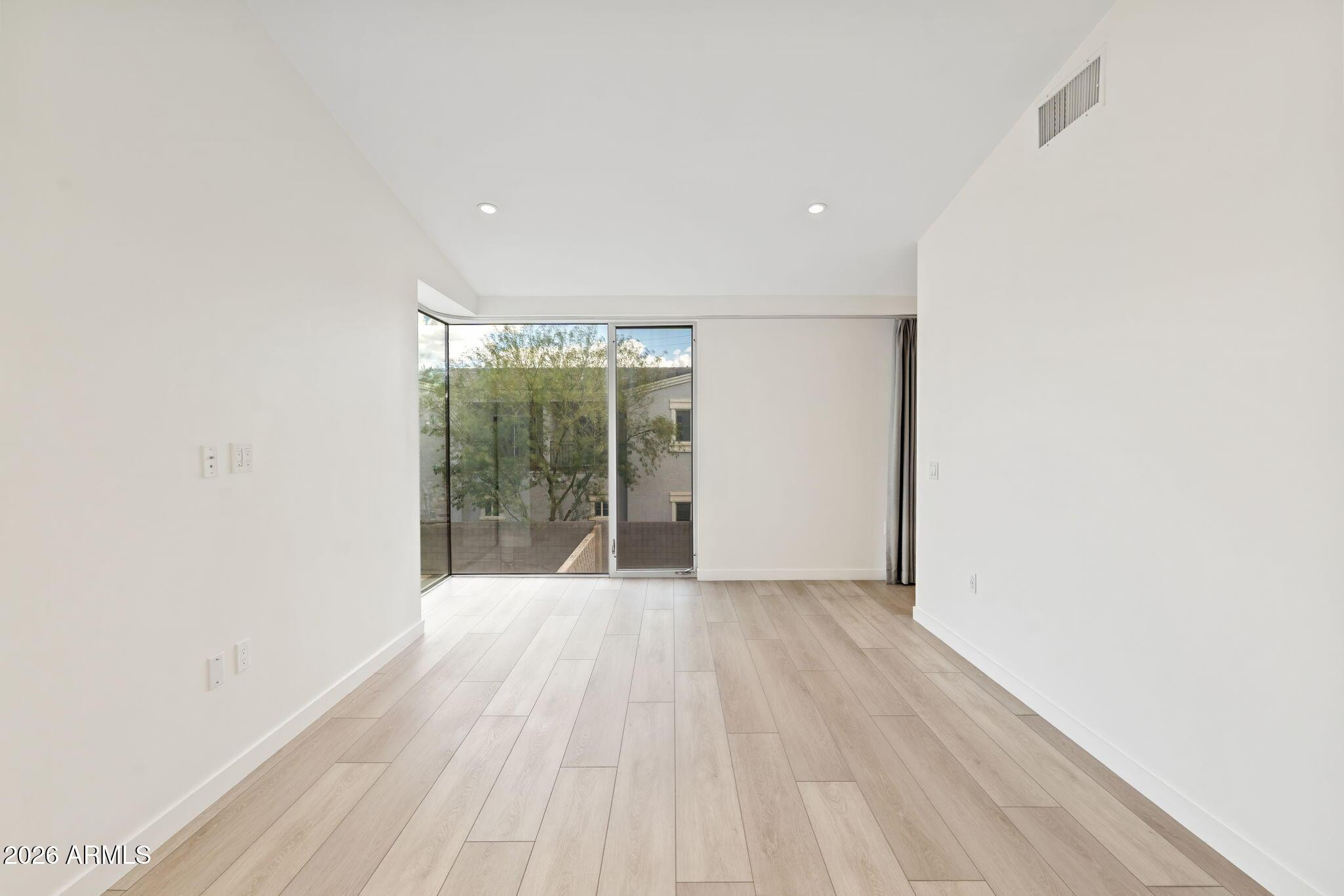 1337 East Polk Street, Unit 7 Phoenix, AZ 85006 - Photo 17 of 25 a view of an empty room with wooden floor