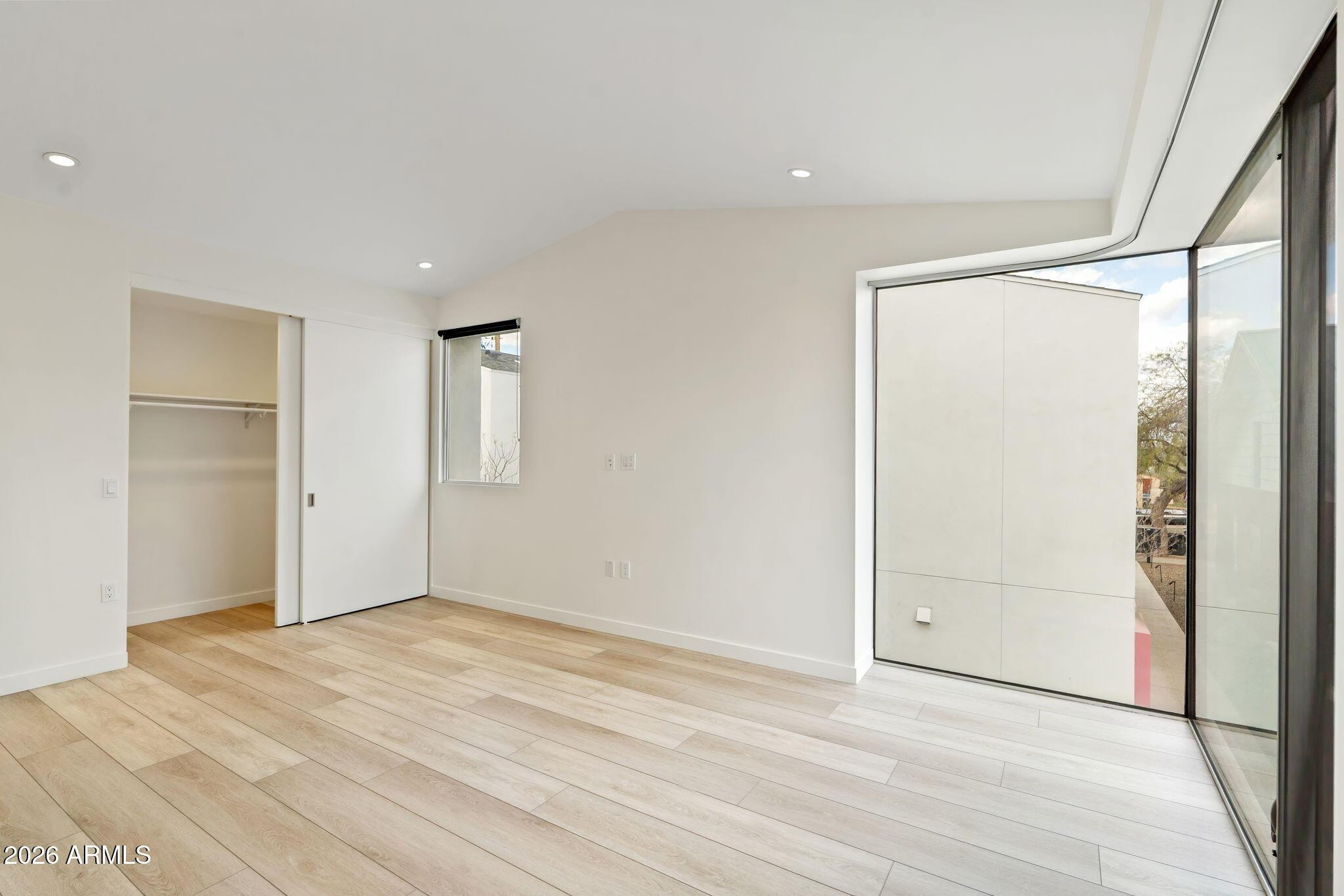1337 East Polk Street, Unit 7 Phoenix, AZ 85006 - Photo 18 of 25 an empty room with a wooden door