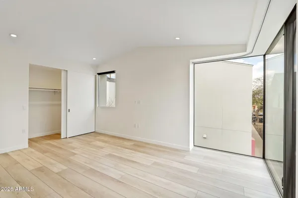a view of a kitchen with wooden floor and electronic appliances