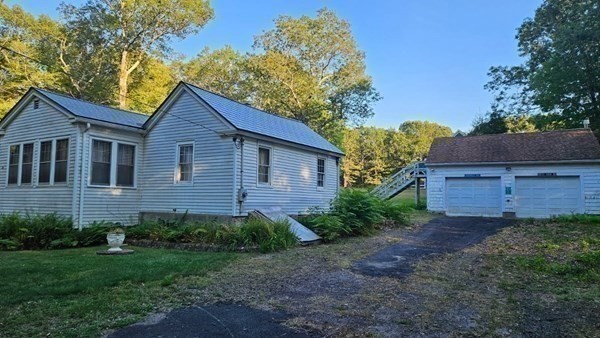 288 High Street Uxbridge, MA 01569 - Photo 12 of 24 a view of a brick house with a yard and large trees