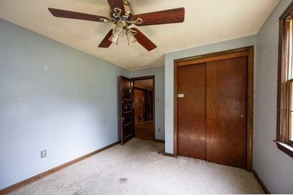 288 High Street Uxbridge, MA 01569 - Photo 18 of 24 an empty room with closet and a chandelier fan
