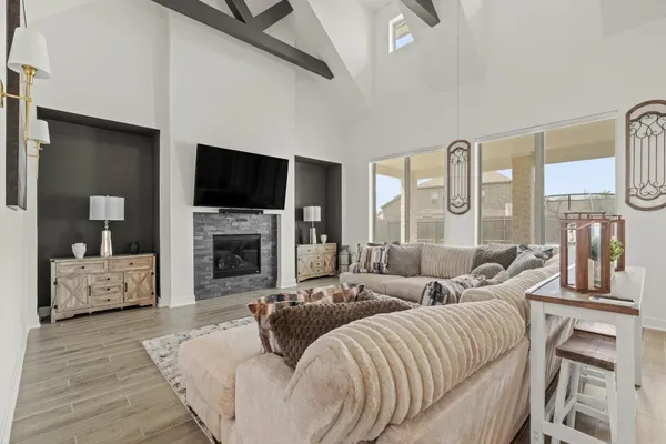 a living room with furniture fireplace and a flat screen tv