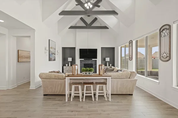 a living room with furniture a large window and a fireplace