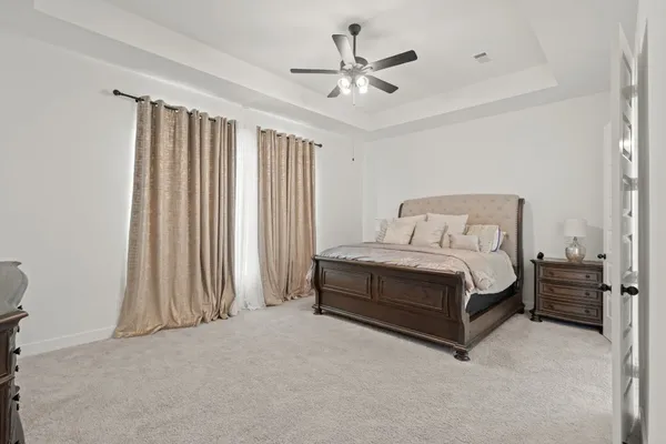 a bedroom with a bed and a chandelier