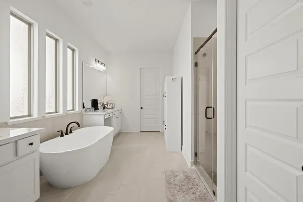 a bathroom with a bathtub and windows