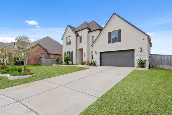 a front view of house with yard and green space