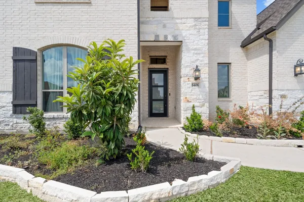 a front view of a house with garden
