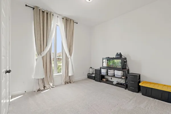 a view of a room with furniture and a window