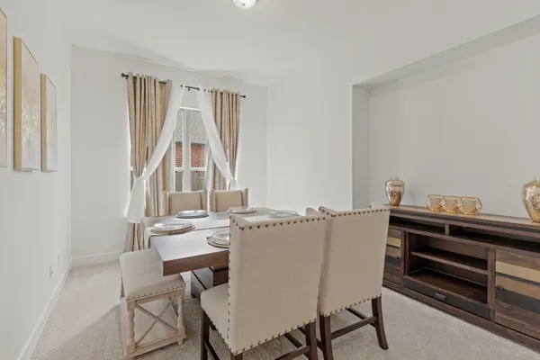 a view of a dining room with furniture and a window