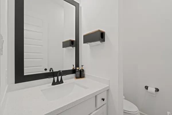 a bathroom with a sink toilet and mirror