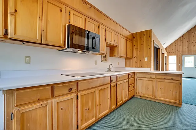 a kitchen with stainless steel appliances granite countertop white cabinets a sink and dishwasher