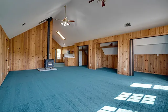 a view of an empty room with a fireplace
