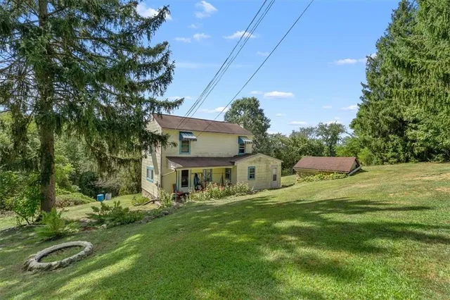 a front view of a house with a yard table and chairs