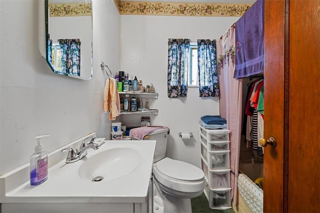 1182 Airport Road Aliquippa, PA 15001 - Photo 19 of 25 a bathroom with a sink toilet and a mirror