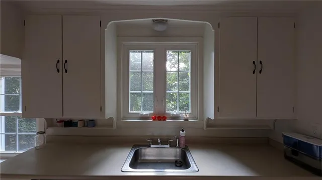 a bathroom with a sink a bathtub and a window