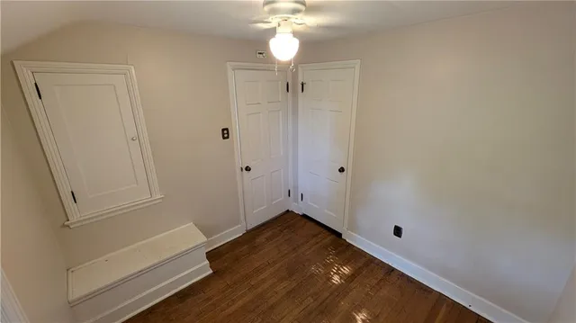 a view of room with hardwood floor and fan