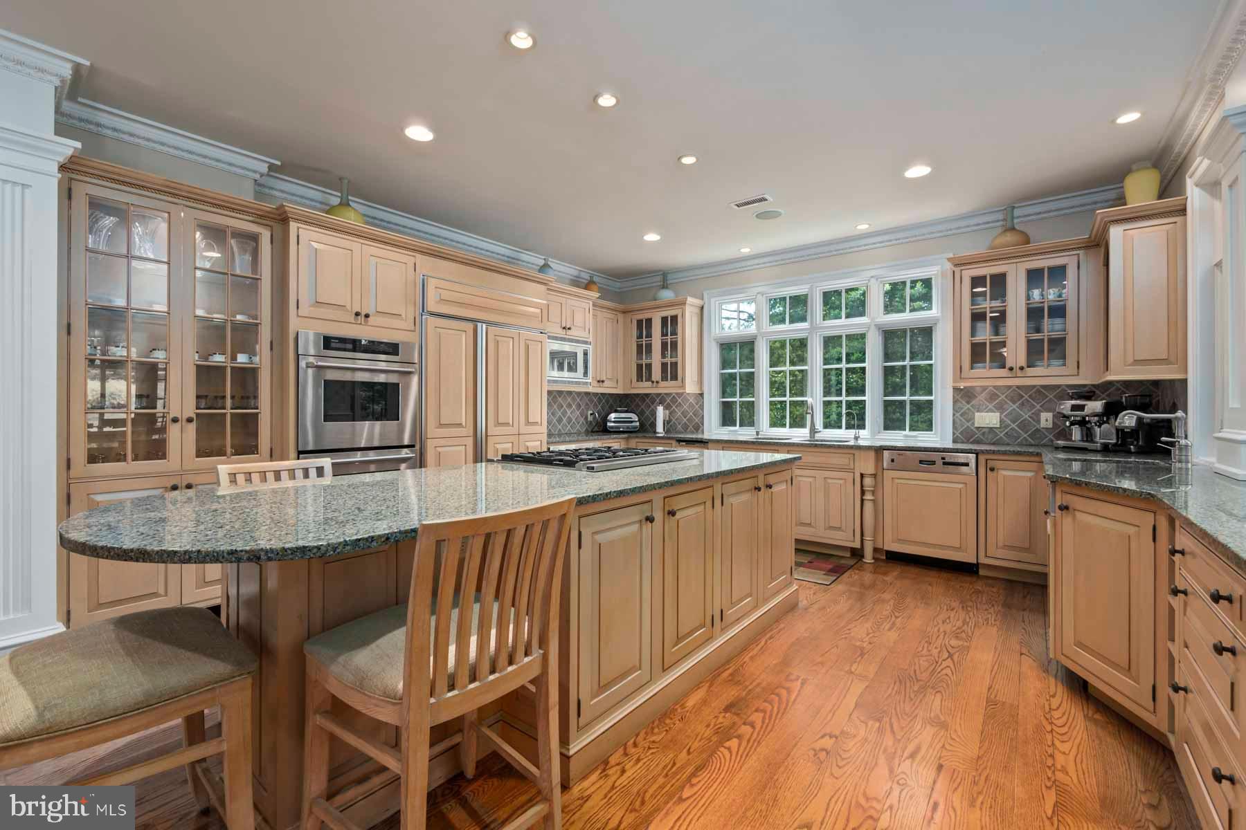 2 Matlack Lane Villanova, PA 19085 - Photo 39 of 83 a kitchen with stainless steel appliances granite countertop lots of counter space and wooden floors