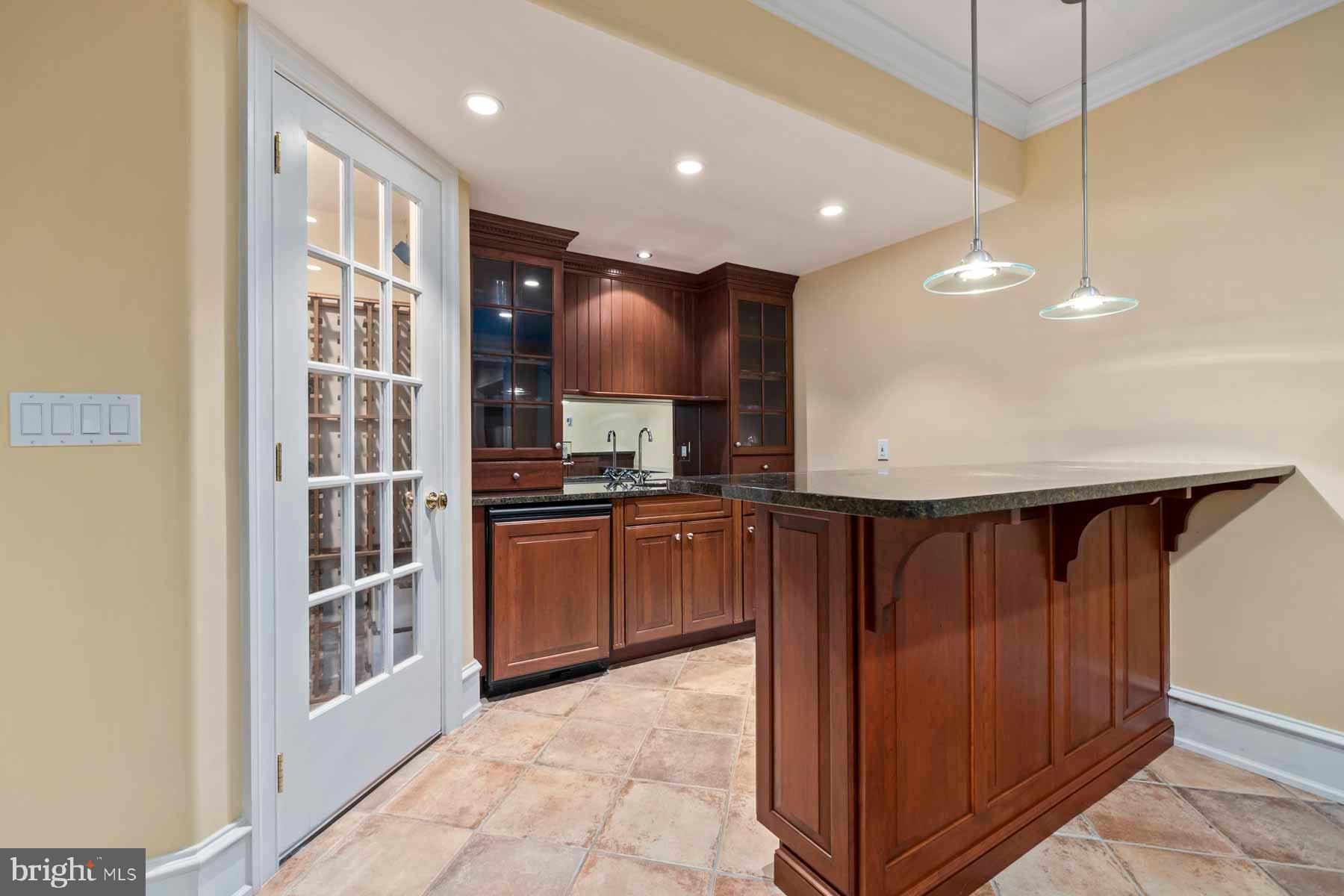 2 Matlack Lane Villanova, PA 19085 - Photo 52 of 83 a kitchen with stainless steel appliances granite countertop a refrigerator a sink and wooden cabinets