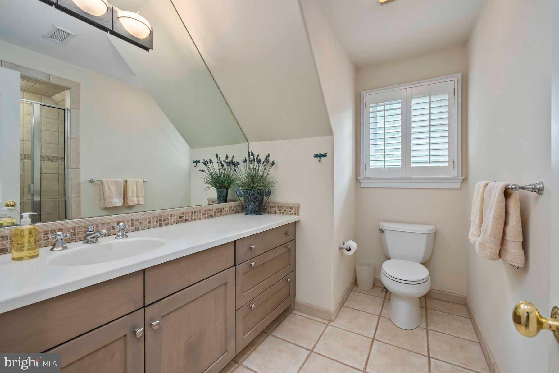 2 Matlack Lane Villanova, PA 19085 - Photo 75 of 83 a spacious bathroom with a granite countertop sink a toilet a mirror and a window