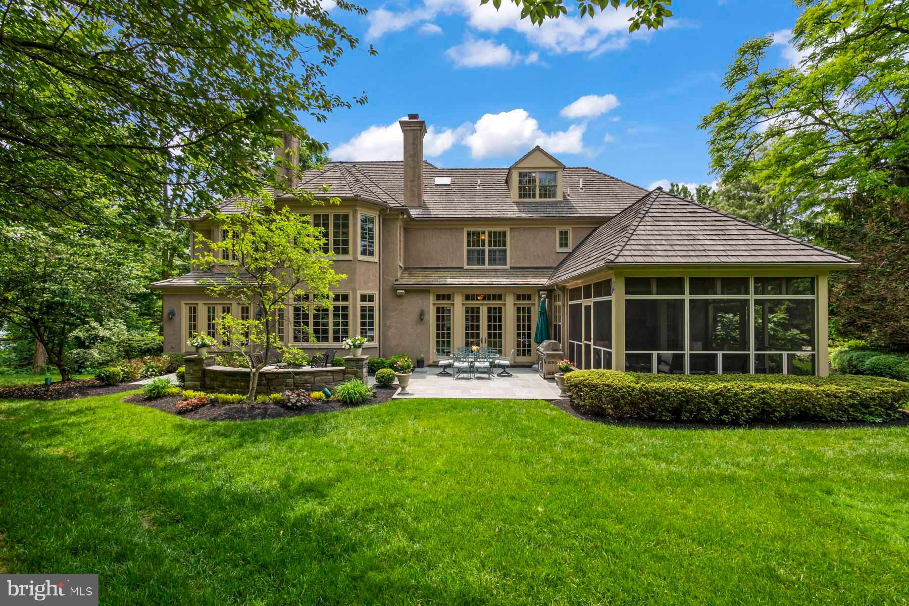 2 Matlack Lane Villanova, PA 19085 - Photo 8 of 83 a front view of a house with a yard table and chairs