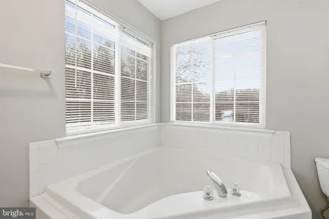 a white bath tub sitting next to a window