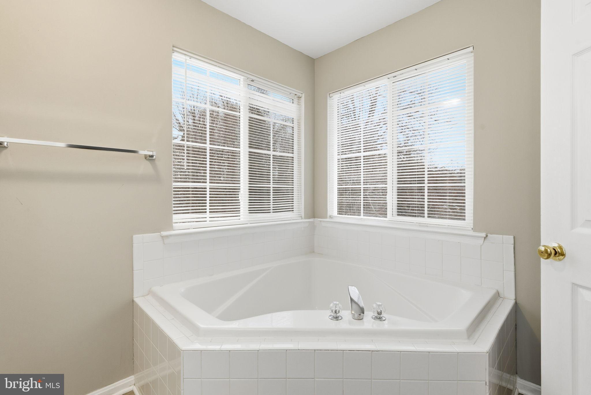 907 Vauxhall Road Landover, MD 20785 - Photo 16 of 37 a white bath tub sitting next to a window