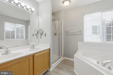 a bathroom with a tub sink and mirror