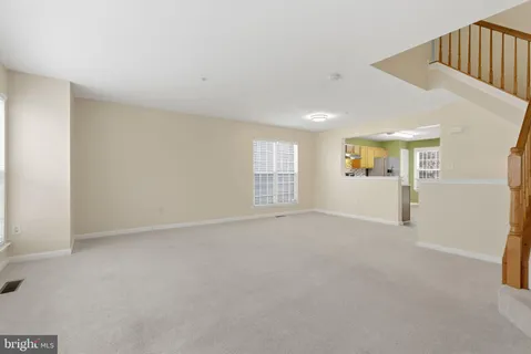 a view of an empty room with stairs