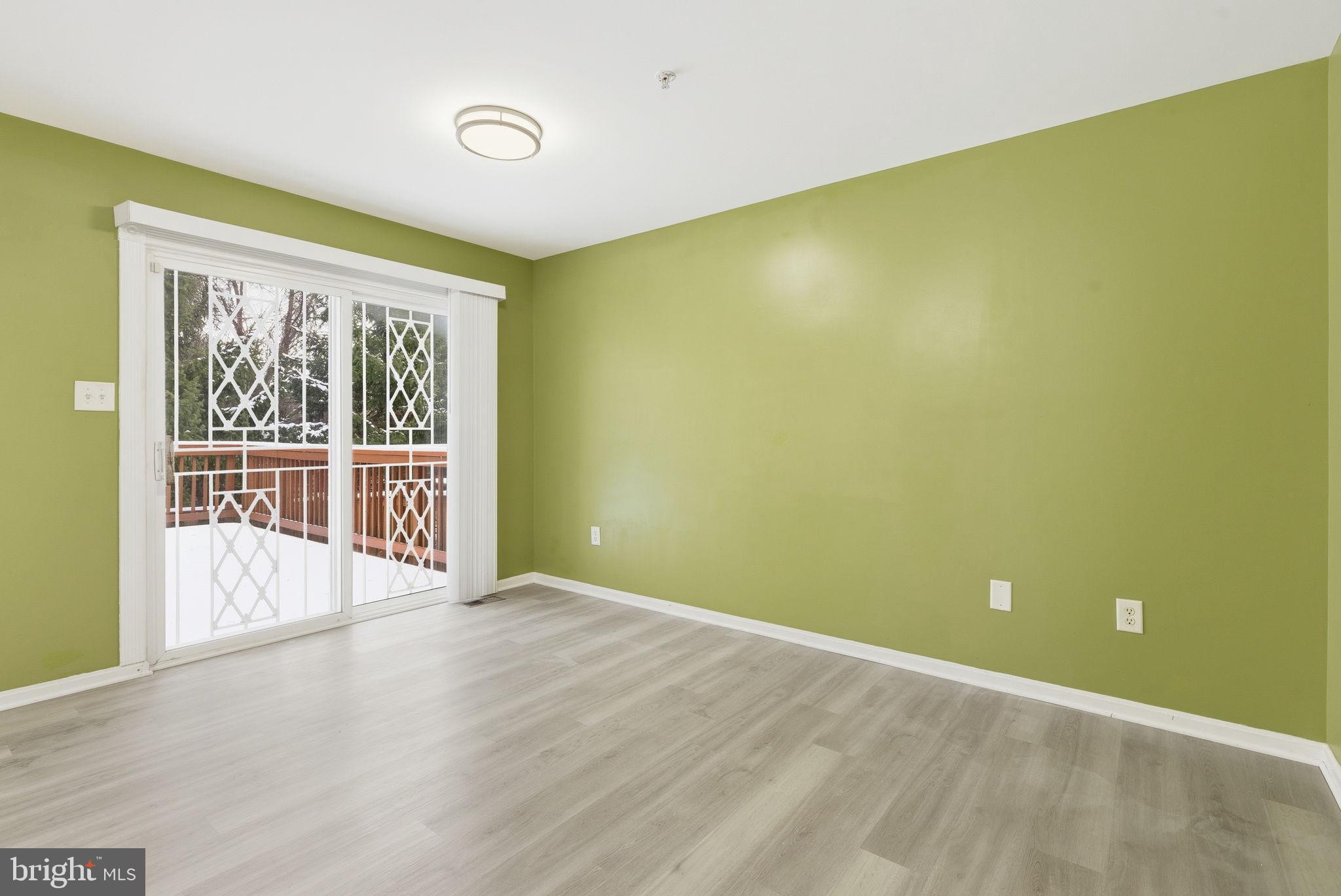 907 Vauxhall Road Landover, MD 20785 - Photo 28 of 37 a view of a big room with wooden floor and windows
