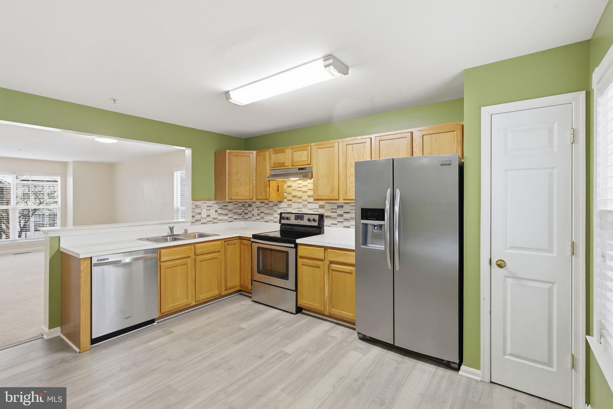 907 Vauxhall Road Landover, MD 20785 - Photo 32 of 37 a kitchen with stainless steel appliances granite countertop a refrigerator a stove top oven and sink