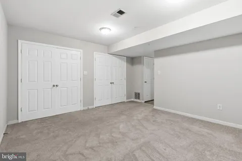 an empty room with a projector and cabinets