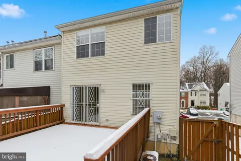 a view of house with deck and outdoor seating
