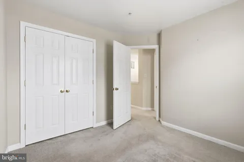 a view of an empty room with closet area