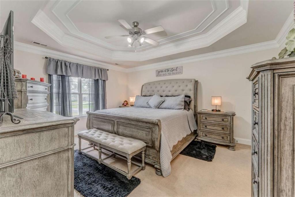 9 Royal Oak Drive Northeast Rome, GA 30165 - Photo 12 of 31 a bedroom with a bed and a chandelier