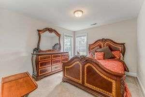 9 Royal Oak Drive Northeast Rome, GA 30165 - Photo 17 of 31 a bedroom with a bed and a chandelier