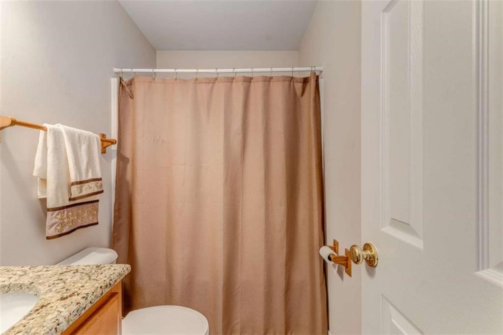 9 Royal Oak Drive Northeast Rome, GA 30165 - Photo 18 of 31 a bathroom with a shower curtain and a sink