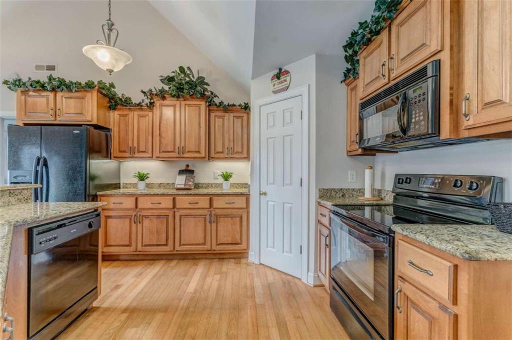 9 Royal Oak Drive Northeast Rome, GA 30165 - Photo 7 of 31 a kitchen with stainless steel appliances granite countertop wooden cabinets stove top oven and sink